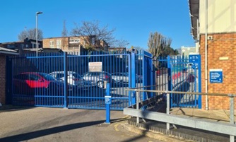 Blue gates at the front of Wembley Community Diagnostic Centre