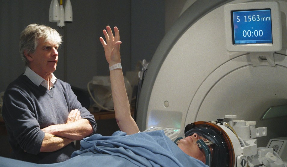 Photo of Lord Fellowes receiving treatment, overseen by Dr Peter Bain