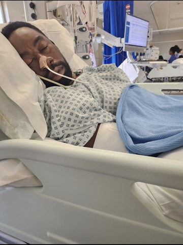 Photo of Matthew recovering in hospital in 2023