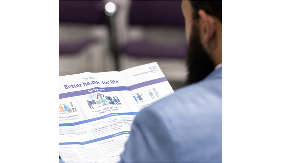 man with beard looking at leaflet