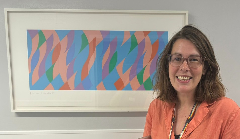 Photo of Dr Katy Bowen with artwork behind her
