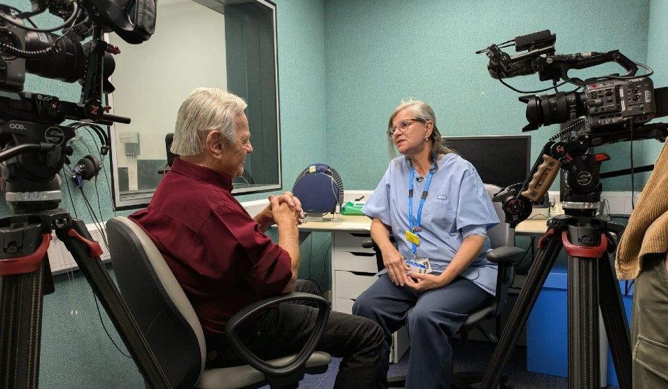 Photo of Renee Almedia being interviewed on camera by journalist Tony Blackburn