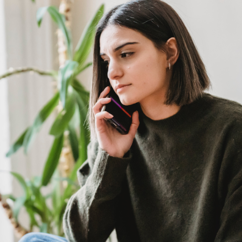 Woman is on the phone and looks concerned