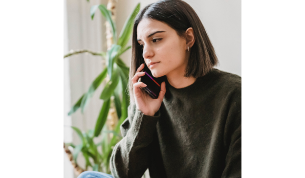 Woman is on the phone and looks concerned