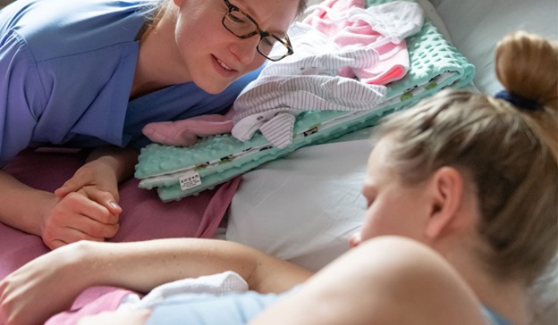Nurse with a mother and her newborn Nurse with a mother and her newborn