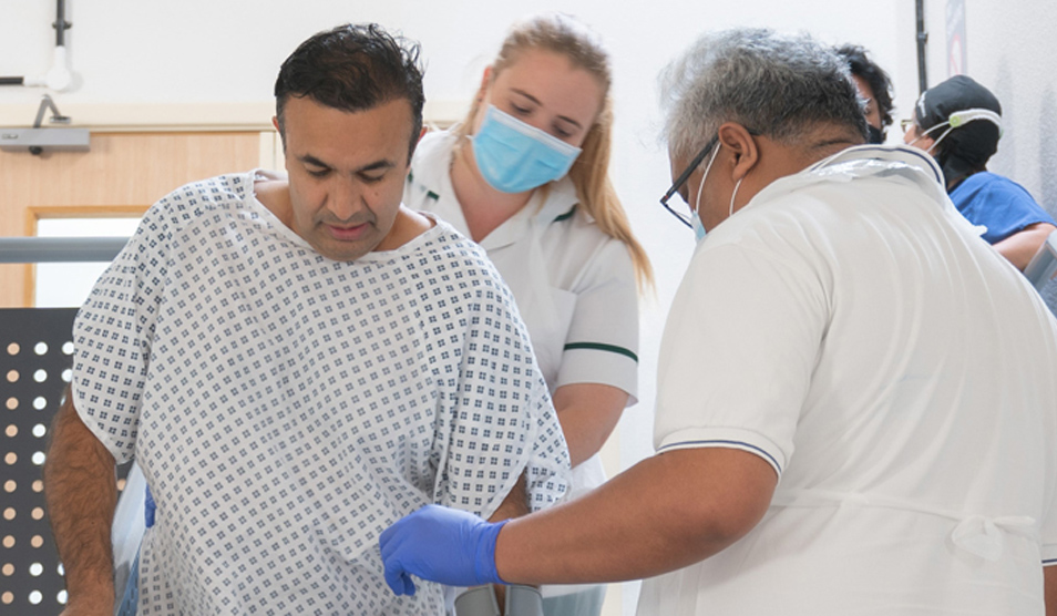 Orthopaedic patient being supported down stairs