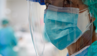 Closeup photo of clinical staff member wearing full PPE Closeup photo of clinical staff member wearing full PPE