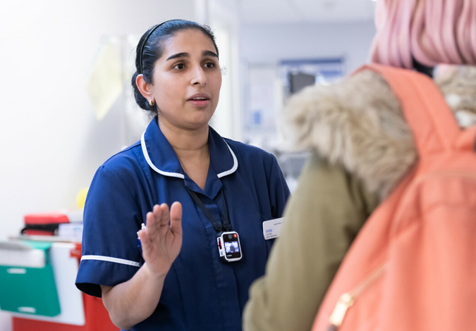 Nurse speaks with a member of the public while sporting a Body Worn Camera (BWC)