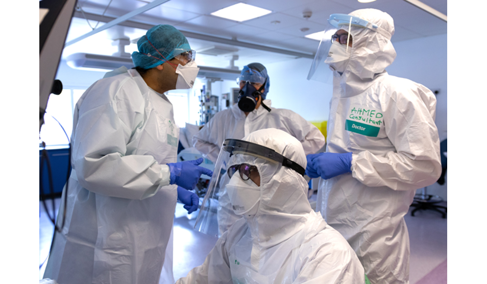 Photo of four clinicians  wearing PPE