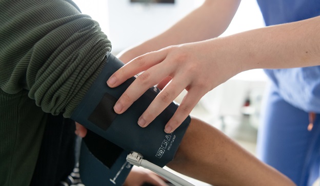Nurse taking patient's blood pressure