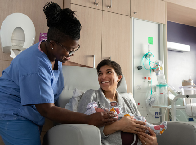 Nurse with mother and newborn