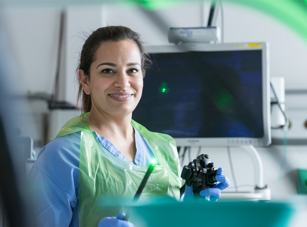 Photograph of clinician using robotics equipment