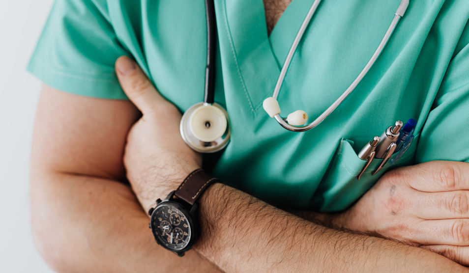 Crop doctor with stethoscope in hospital