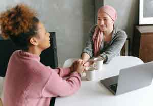 A Woman Holding her Hands with her Friend