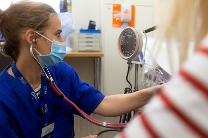 midwife taking patient's blood pressure