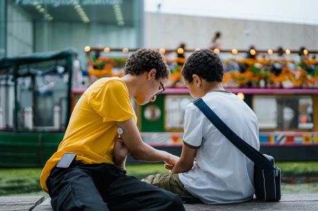 Photo of two adolescent boys sitting together